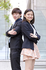 Image showing Young Asian female and male business executive smiling portrait