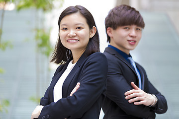 Image showing Young Asian female and male business executive smiling portrait