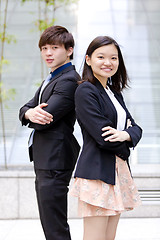 Image showing Young Asian female and male business executive smiling portrait