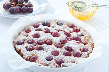 Image showing Fresh cake with red grape season and icing sugar