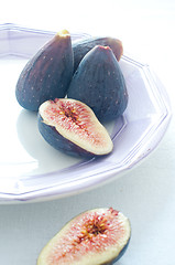 Image showing Group of colored figs on the colorful background