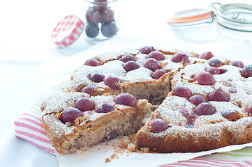 Image showing Fresh cake with red grape season and icing sugar