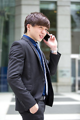 Image showing Young Asian male business executive using smart phone