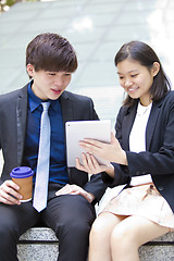 Image showing Young Asian female and male business executive using table