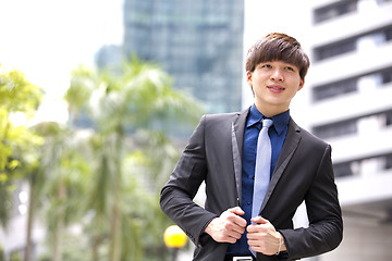 Image showing Young Asian business executive in suit smiling portrait