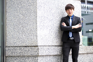 Image showing Young Asian business executive in suit smiling portrait