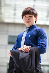 Image showing Young Asian business executive in suit smiling portrait