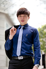 Image showing Young Asian business executive in suit smiling portrait