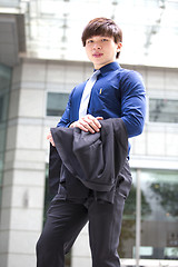 Image showing Young Asian business executive in suit smiling portrait