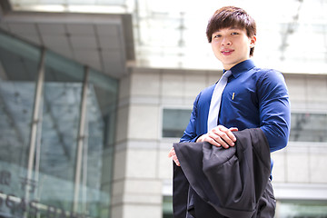 Image showing Young Asian business executive in suit smiling portrait