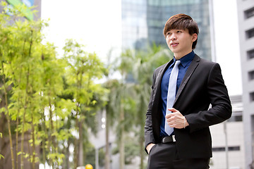 Image showing Young Asian business executive in suit smiling portrait