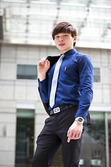 Image showing Young Asian business executive in suit smiling portrait