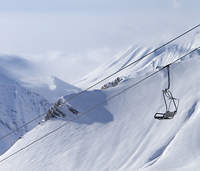 Image showing Chair lift and mountains in fog