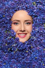 Image showing Closeup  of woman face in cornflower flowers