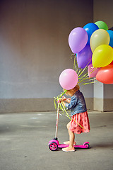 Image showing happy little girl outdoors with balloons