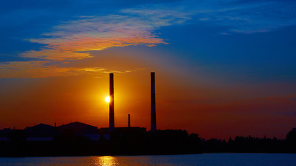 Image showing factory in silhouette and sunrise sky