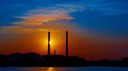 Image showing factory in silhouette and sunrise sky