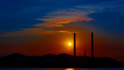 Image showing factory in silhouette and sunrise sky