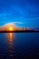 Image showing factory in silhouette and sunrise sky