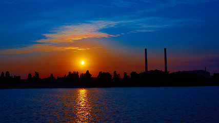 Image showing factory in silhouette and sunrise sky