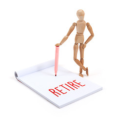 Image showing Wooden mannequin writing - Retire