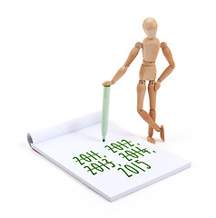 Image showing Wooden mannequin writing - 2015