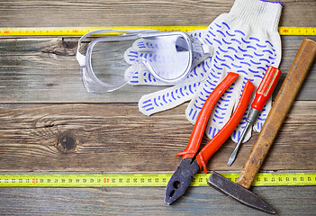 Image showing set of the old locksmith tools, safety glasses and work gloves