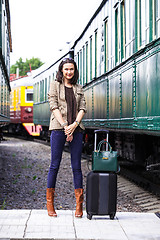 Image showing pretty adult woman with a luggage near the train