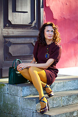 Image showing beautiful middle-aged woman in a burgundy dress