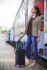 Image showing beautiful middle-aged woman with luggage rides in retro trip