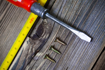 Image showing ancient screwdriver, screws and measuring lenght