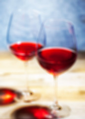 Image showing red wine in two goblets. romantic blur