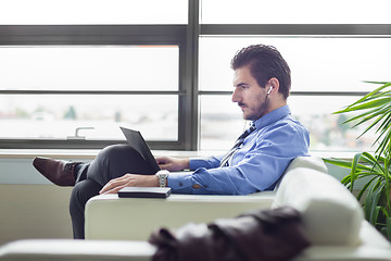 Image showing Businessman in office working on laptop computer.