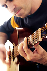 Image showing Man playing a guitar