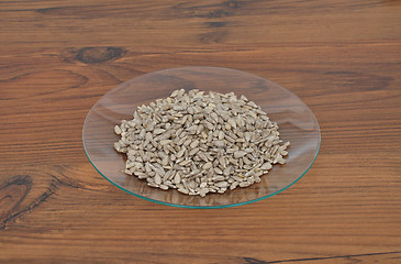 Image showing Plate of glass with sunflower nuts