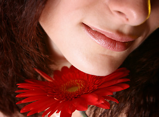 Image showing Girl with a red flower