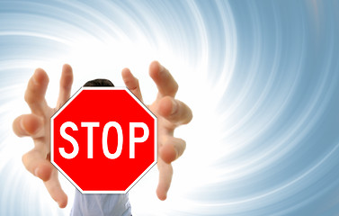 Image showing Man grabing a stop sign