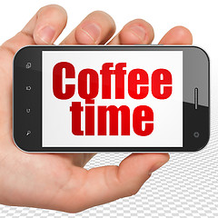 Image showing Time concept: Hand Holding Smartphone with Coffee Time on display