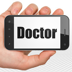 Image showing Healthcare concept: Hand Holding Smartphone with Doctor on display