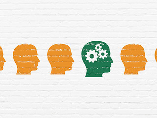 Image showing Learning concept: head with gears icon on wall background