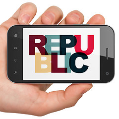 Image showing Political concept: Hand Holding Smartphone with Republic on  display