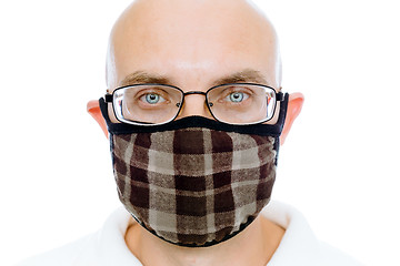 Image showing Bald man on a white background in the warm medical mask