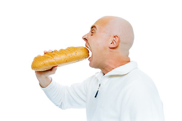 Image showing man biting a loaf. Isolated on white. Profile