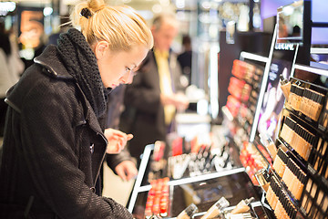 Image showing Beautiful woman shopping in beauty store.