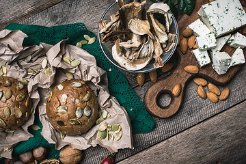 Image showing Autumn harvest nuts mushrooms cheese and bread buns 