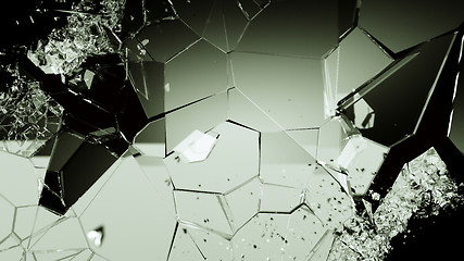 Image showing Pieces of cracked glass on black