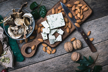Image showing Cheese with dill, nuts mushrooms  and on wooden table