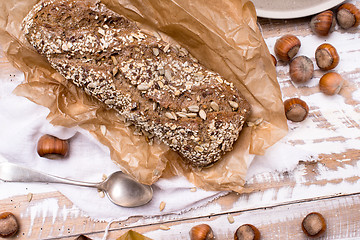 Image showing Bread with seeds huzelnuts on wooden board