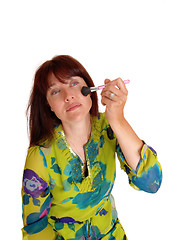 Image showing Woman putting on makeup.