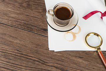 Image showing Coffee cup, paper sheets and detective hat